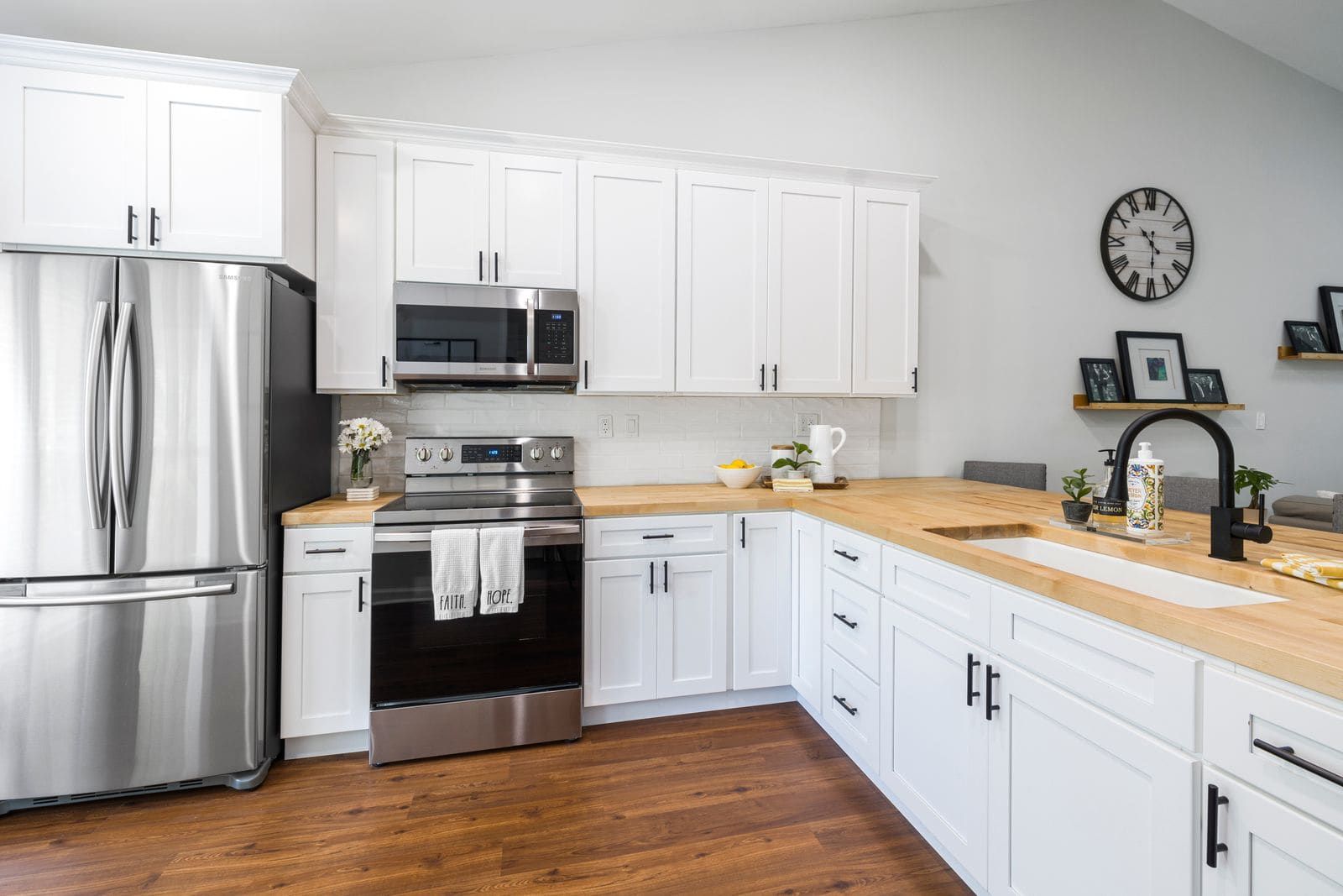 Wood butcher block countertop run in a white shaker kitchen