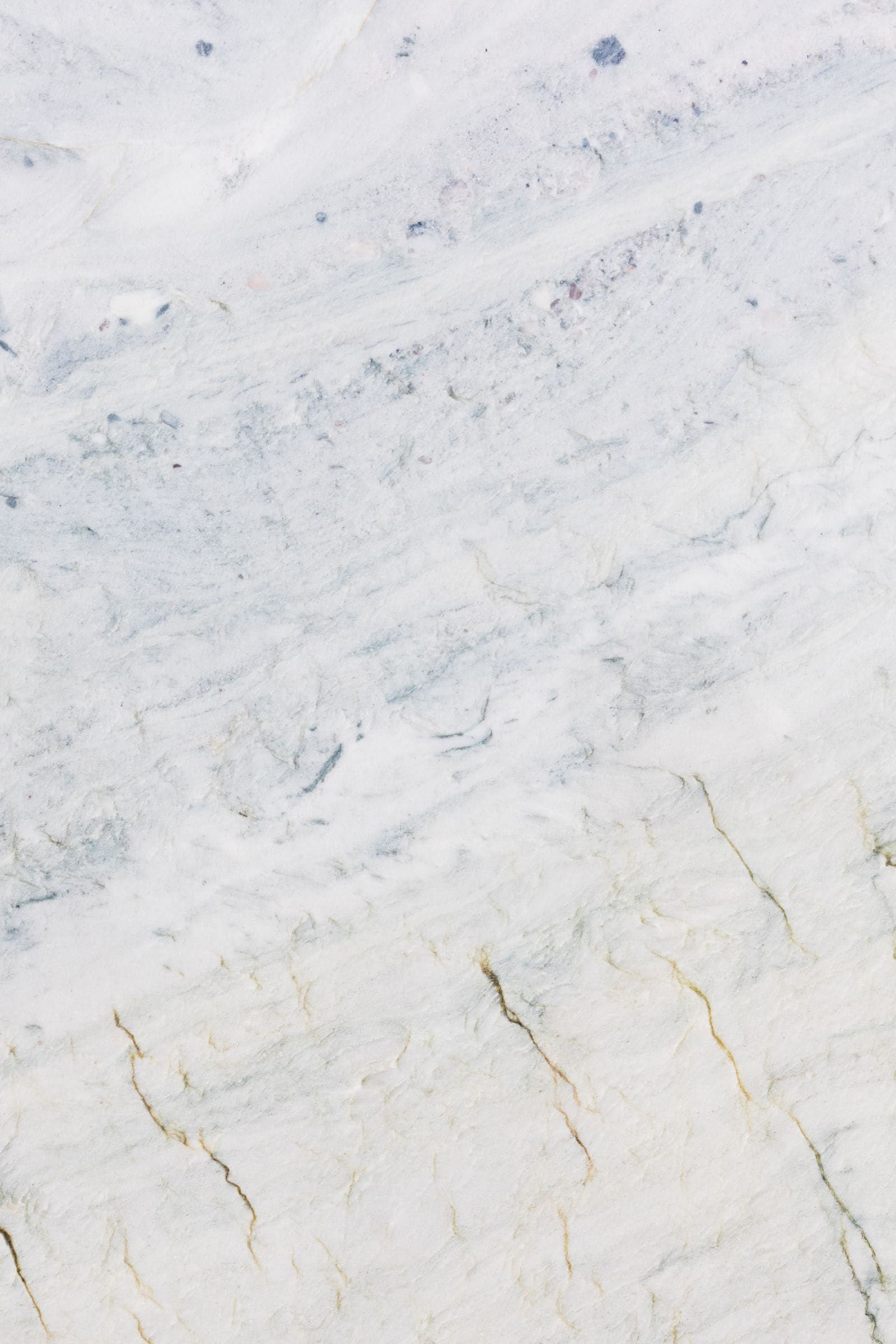 White marble slab surface with soft grey and gold veining