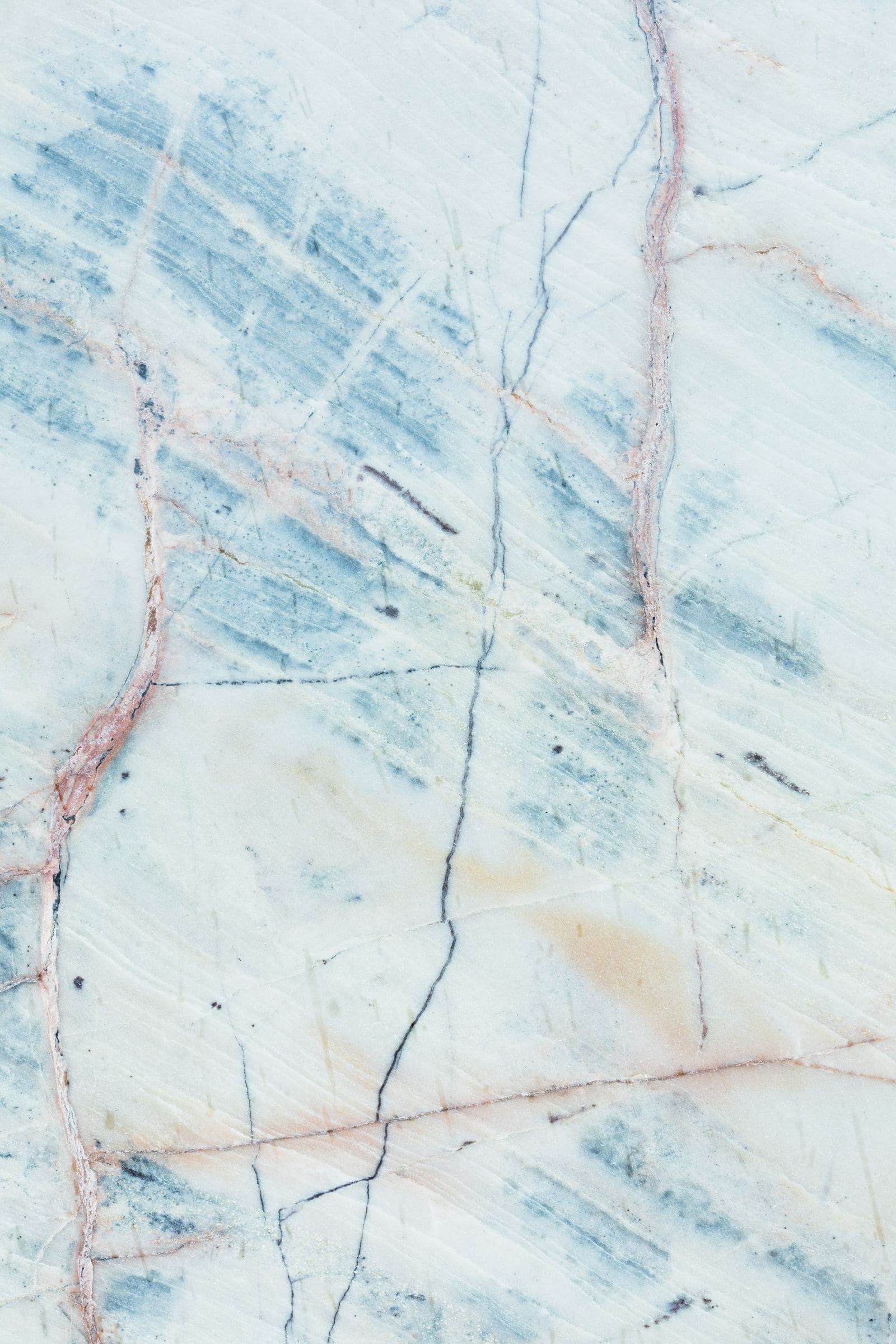 White quartzite slab with blue-grey and rust veining